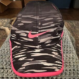 Camo, pink, black dri-fit Nike kids hats.